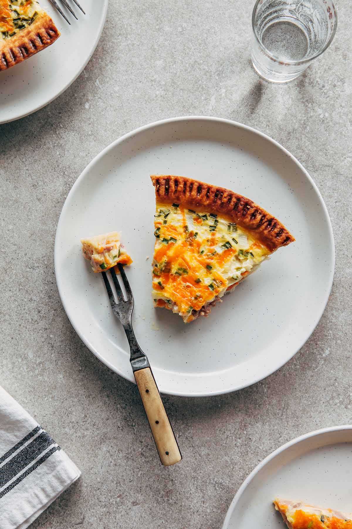 A slice of buttermilk quiche on a plate with a fork.