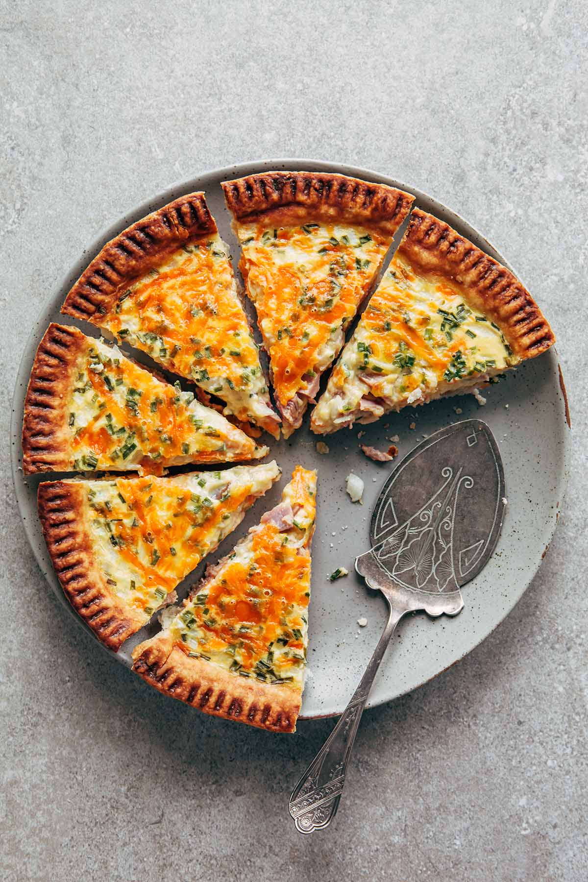 A whole sliced buttermilk quiche with two slices removed.