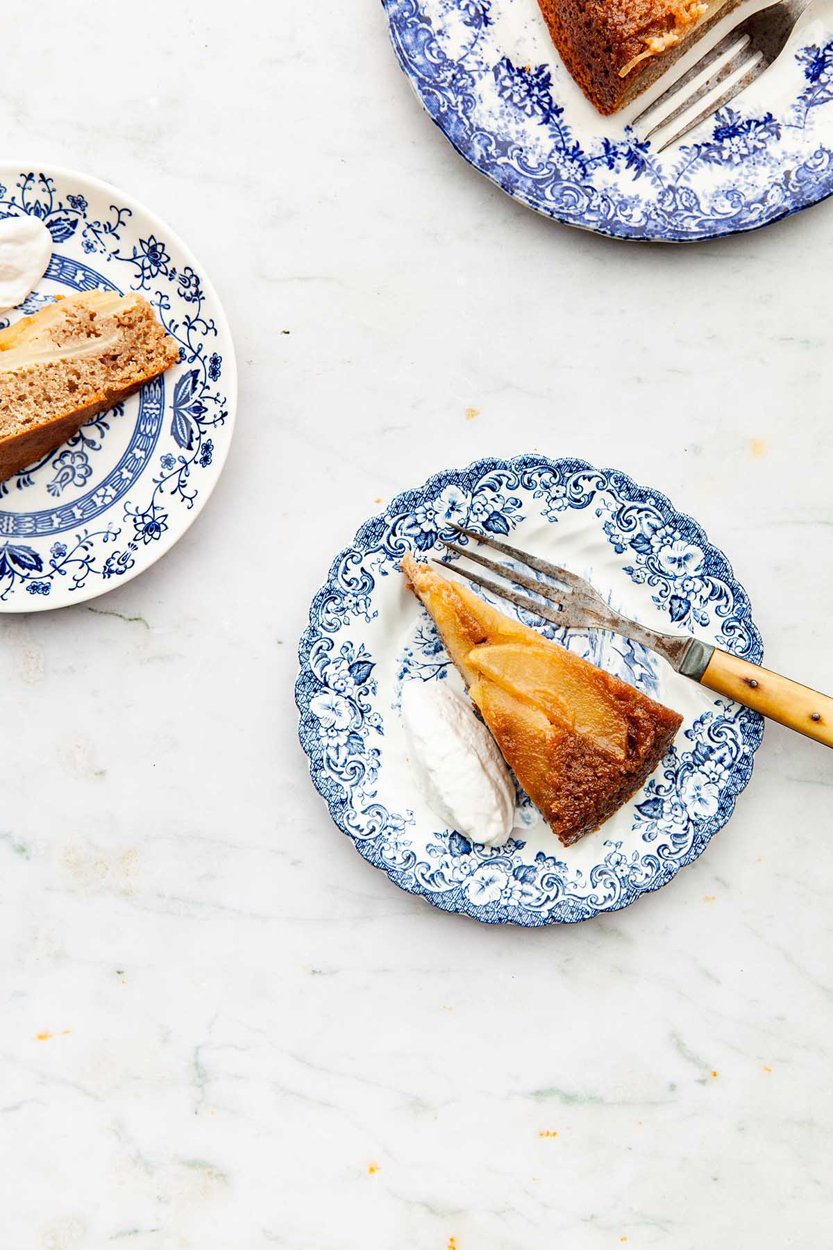 Overhead image of slices of chai cake on blue and white plates.